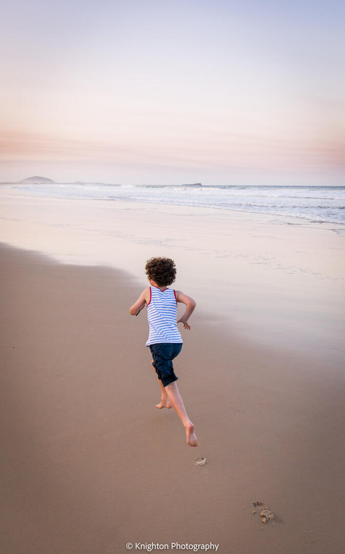 Boy portrait at sunset on the beach