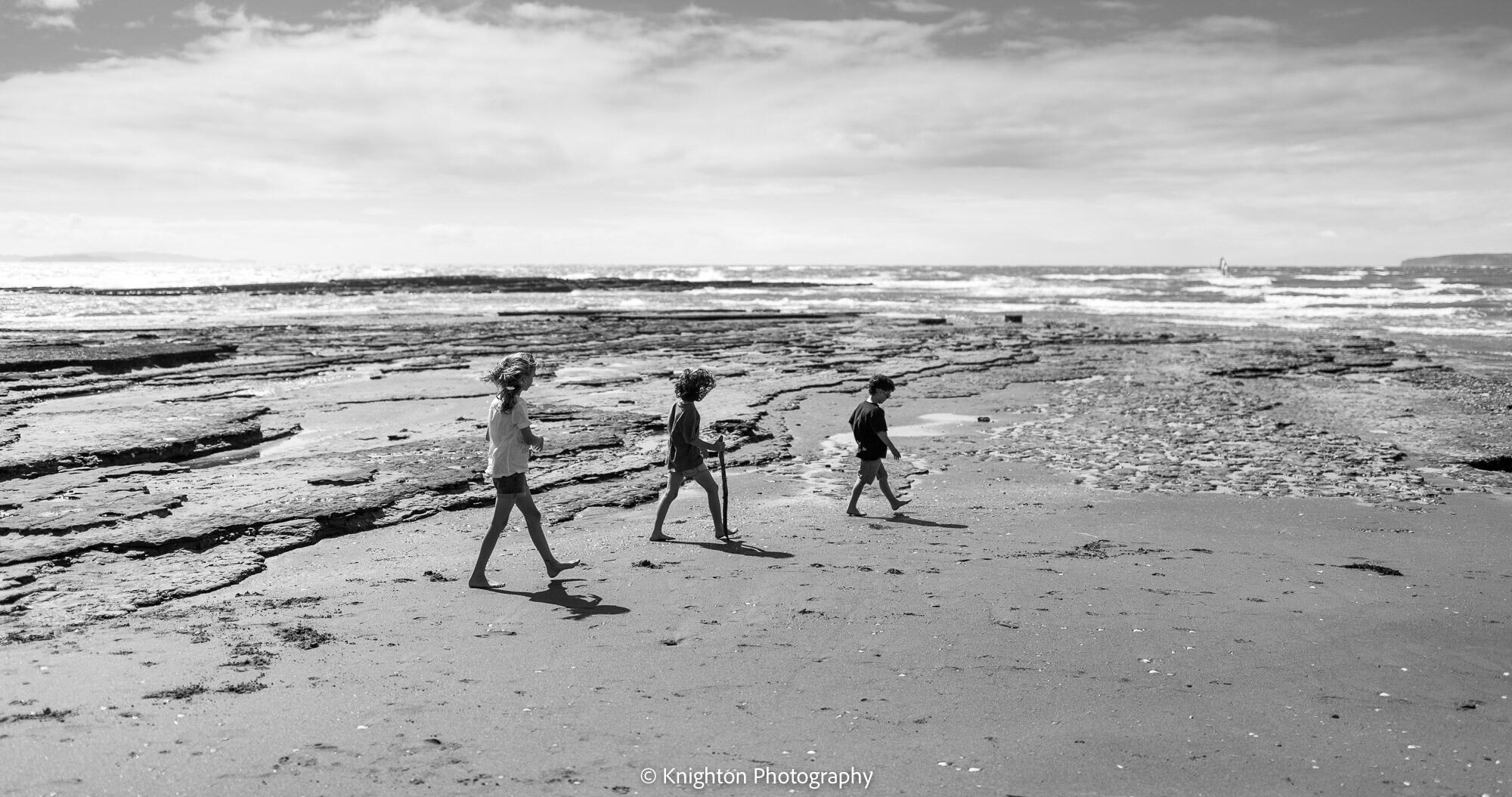 Siblings go for a walk at the beach